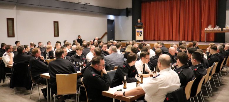 Bild von der Feuerwehr-Dienstveranstaltung im vollbesetzten Knappensaal in Herdorf, an den Tischen befinden sich die Feuerwehrleute.